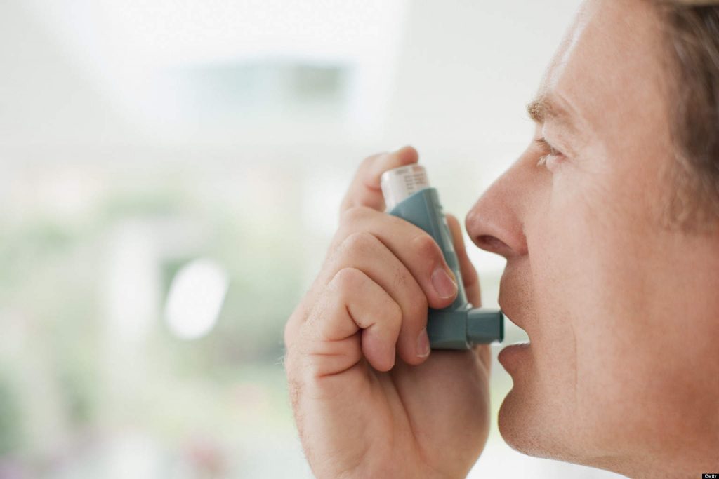 Man about to use asthma inhaler