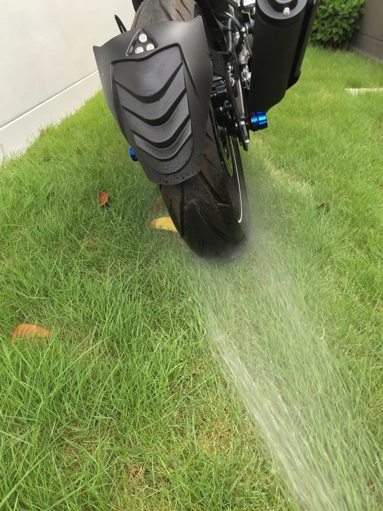 Pressure wash at a distance to avoid damaging your motorcycle.